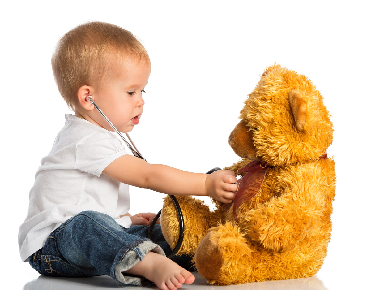 baby plays in doctor toy bear and stethoscope