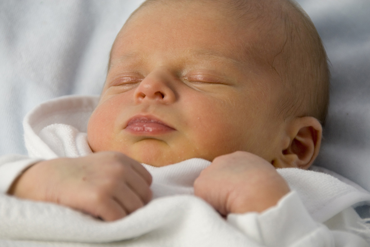 Newborn baby boy with jaundice on his face.